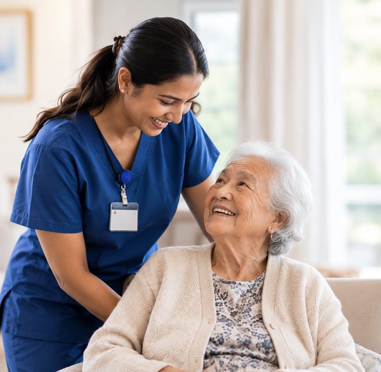 A nurse and a resident sharing a smile in the lounge